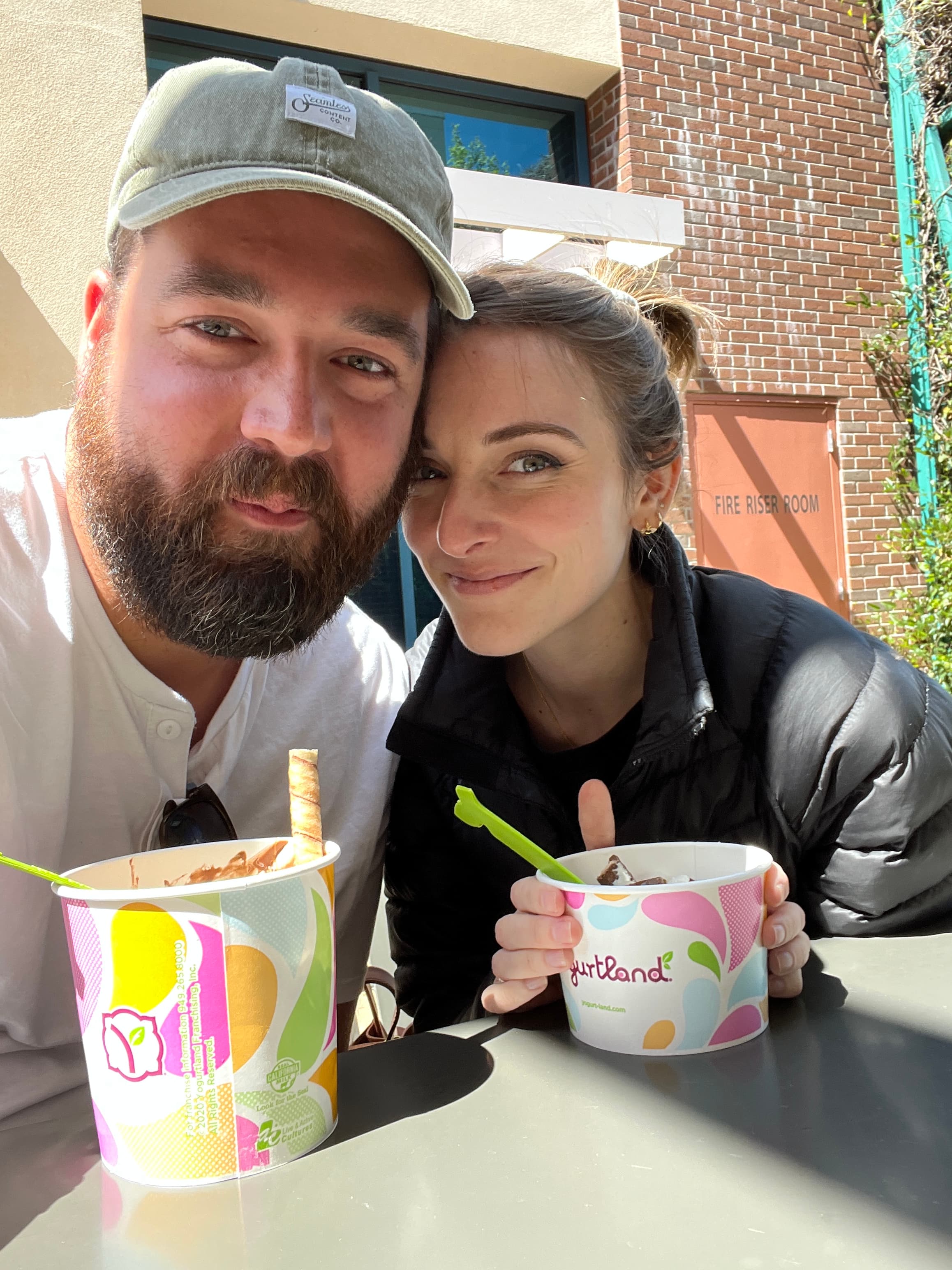 Justin and Shaina Witt sharing ice cream outdoors.